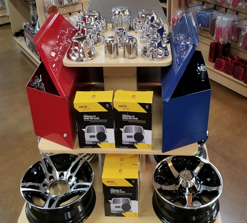 Trailer spare tire covers and tool boxes
